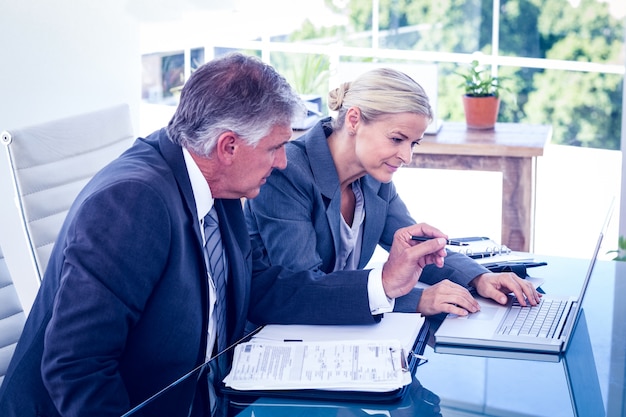 Technology accounting workspace with code screens and financial data